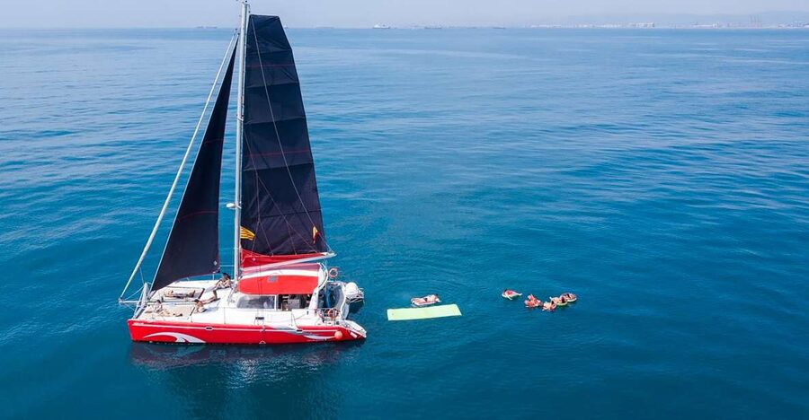 Barcelona: Sunset or Day Catamaran Cruise with Tapa & Drink - The daytime cruise and its 30-minute swim stop