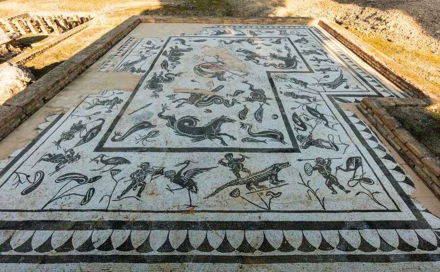 From Seville: Italica Roman City & Medieval Monastery Tour - Entering the amphitheater and Dragonpit