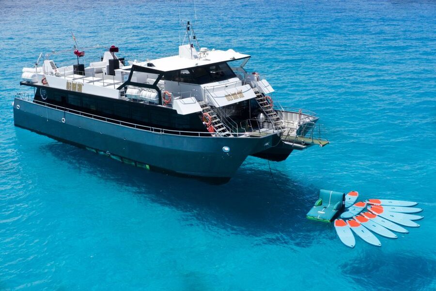 Ibiza: Formentera Cruise at Ibiza Boat Club - Returning to the catamaran for swimming and drinks