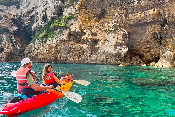 Kayak Paradise: Cala Portixol Snorkel, Cave & Cliff Jumping Tour - Cala el Pom, clear water and underwater rock