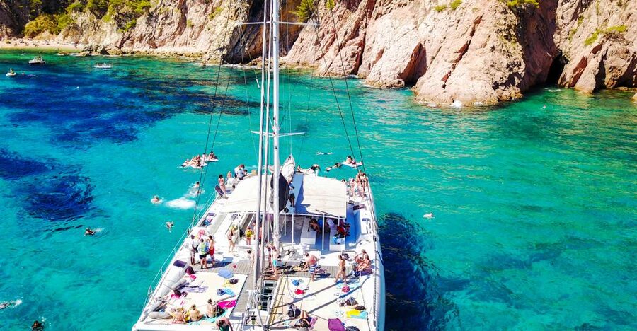 Lloret de Mar: Catamaran Sailing Cruise with BBQ and Drinks - The first hour: cliffs, caves, and coastal villages